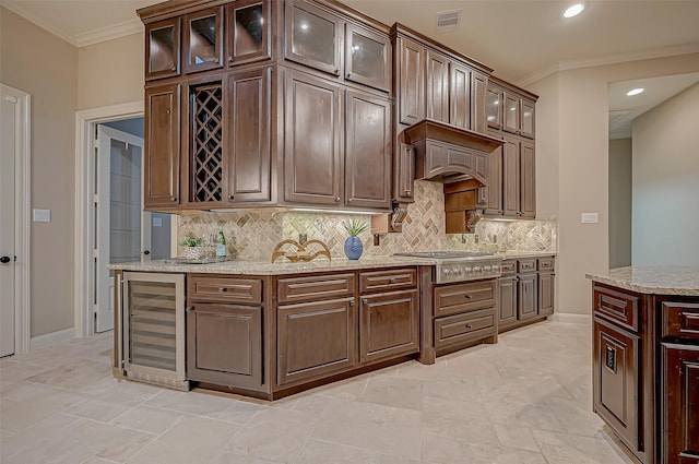 kitchen with dark brown cabinetry, beverage cooler, visible vents, glass insert cabinets, and stainless steel gas cooktop