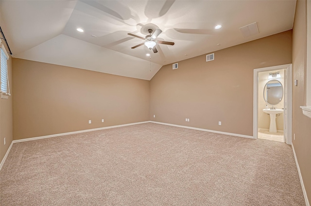 empty room featuring lofted ceiling, ceiling fan, recessed lighting, visible vents, and carpet