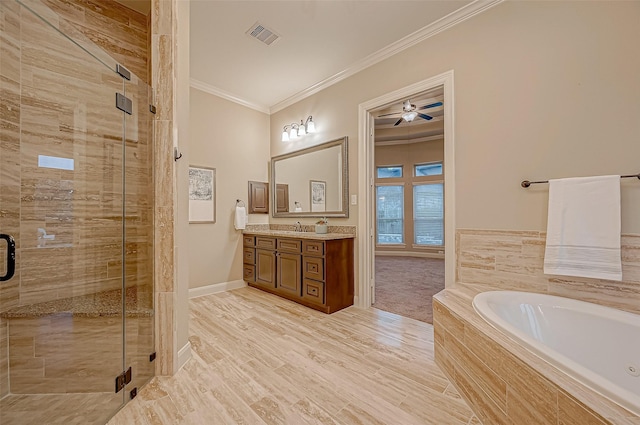 full bath featuring a stall shower, visible vents, ornamental molding, a garden tub, and vanity