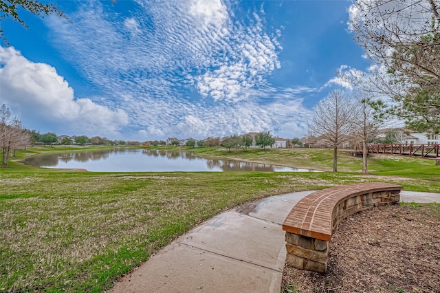 exterior space with a water view and a lawn