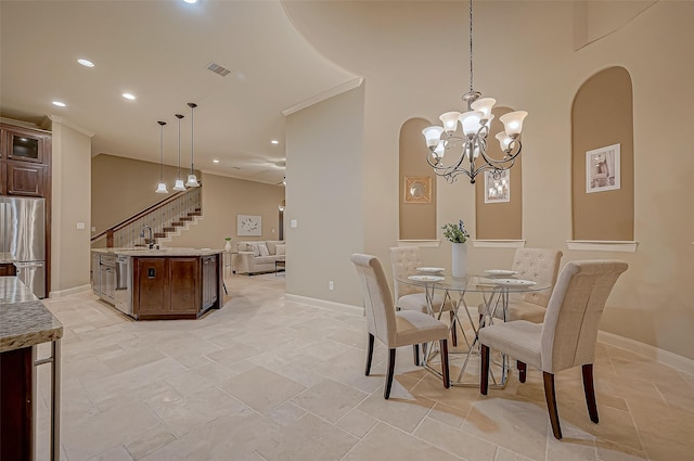 dining room with arched walkways, recessed lighting, stairway, and baseboards