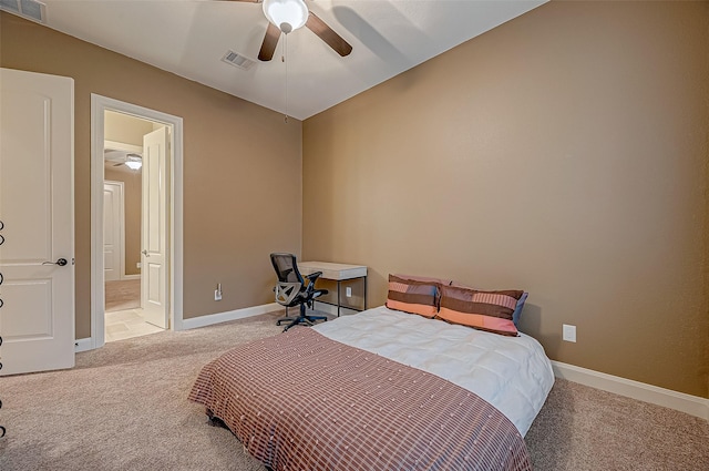 bedroom featuring ensuite bath, baseboards, visible vents, and light colored carpet