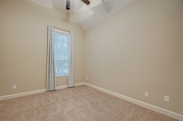 carpeted spare room featuring a ceiling fan, lofted ceiling, and baseboards