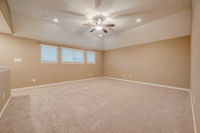 carpeted spare room featuring baseboards, vaulted ceiling, a ceiling fan, and recessed lighting