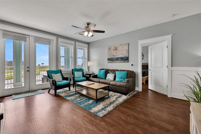 living room featuring dark hardwood / wood-style flooring, french doors, and ceiling fan