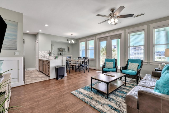 4121 Pointe W Dr Unit 102, Galveston, TX 77554 - living area with healthy amount of natural light, a ceiling fan, baseboards, light wood-type flooring, and recessed lighting