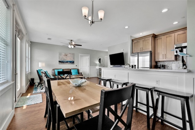 4121 Pointe W Dr Unit 102, Galveston, TX 77554 - dining room featuring wood finished floors, a ceiling fan, a chandelier, baseboards, and recessed lighting