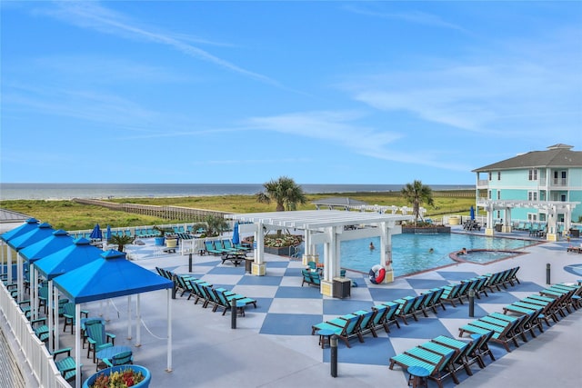 4121 Pointe W Dr Unit 102, Galveston, TX 77554 - view of swimming pool featuring a water view and a pergola