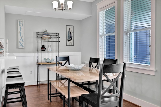 4121 Pointe W Dr Unit 102, Galveston, TX 77554 - dining area featuring dark wood-style floors, baseboards, and a chandelier