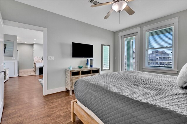 4121 Pointe W Dr Unit 102, Galveston, TX 77554 - bedroom featuring wood finished floors, baseboards, access to exterior, and ceiling fan