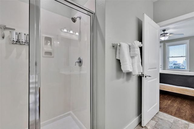 bathroom featuring ceiling fan and a shower with shower door