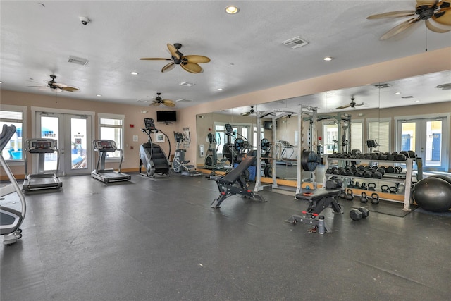 workout area featuring plenty of natural light, a textured ceiling, and french doors