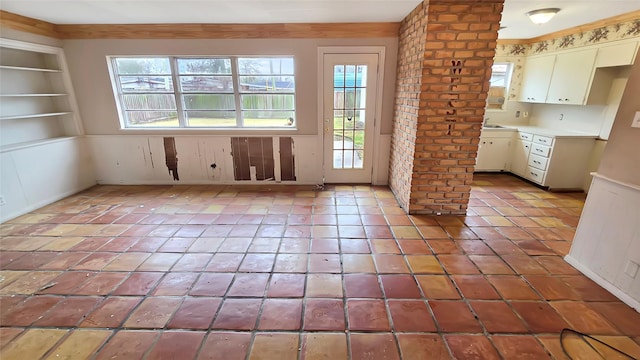 interior space featuring light tile patterned flooring, a wealth of natural light, and built in features