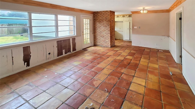 unfurnished room featuring crown molding and light tile patterned floors