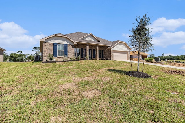 view of front of house with a garage and a front lawn