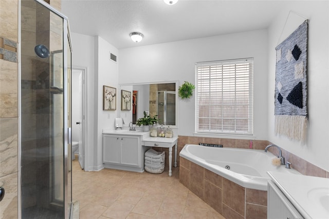 full bathroom featuring plus walk in shower, vanity, toilet, tile patterned floors, and a textured ceiling