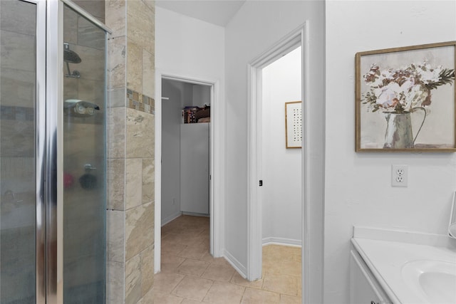 bathroom featuring vanity, tile patterned floors, and a shower with door