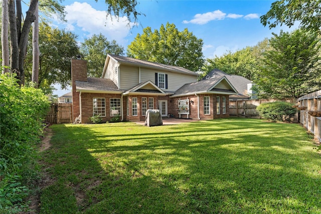 back of property featuring a yard and a patio