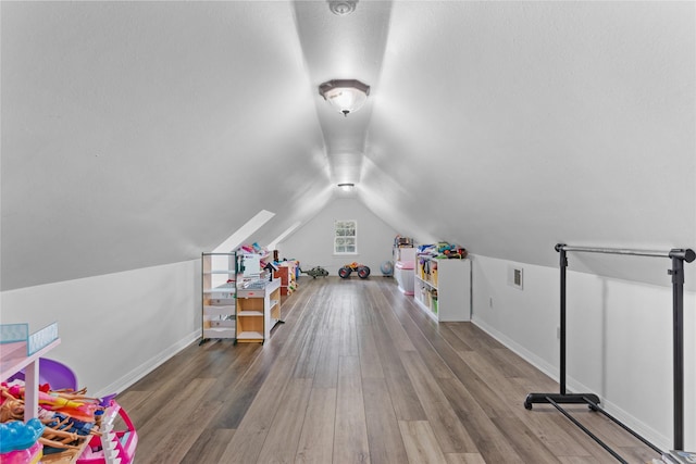 recreation room featuring hardwood / wood-style flooring and lofted ceiling