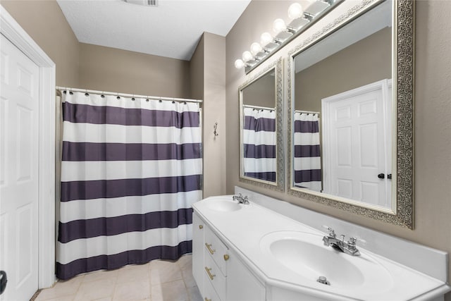 bathroom featuring a shower with curtain, vanity, and tile patterned flooring