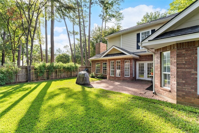 view of yard with french doors and a patio