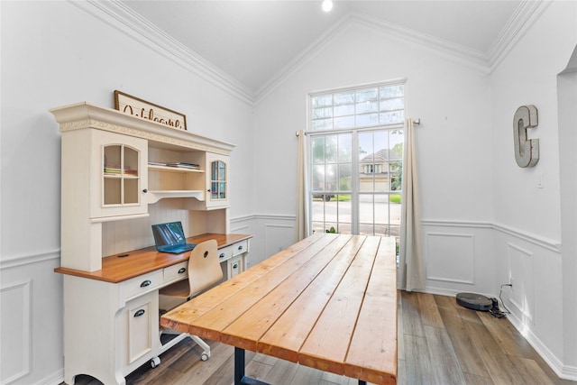 office space featuring light hardwood / wood-style flooring, ornamental molding, and vaulted ceiling