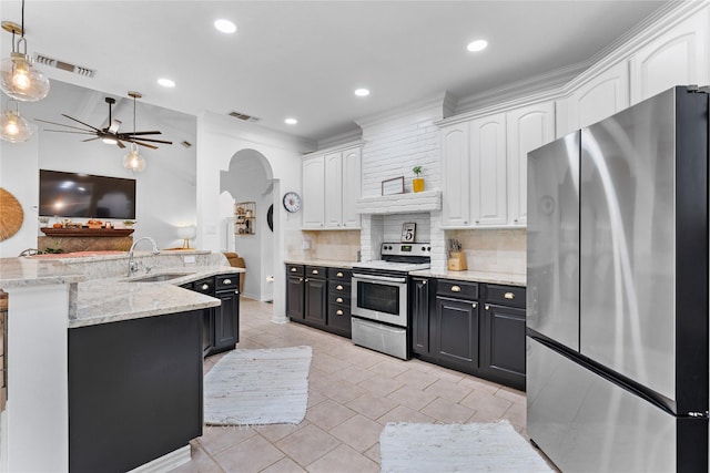 kitchen featuring decorative light fixtures, tasteful backsplash, sink, white cabinets, and stainless steel appliances