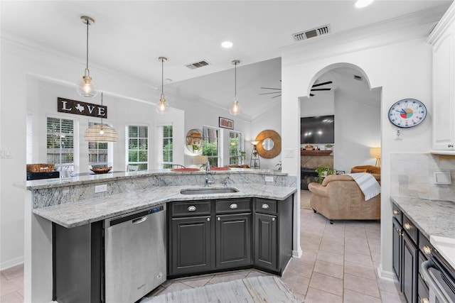 kitchen with light stone countertops, sink, stainless steel dishwasher, and ceiling fan