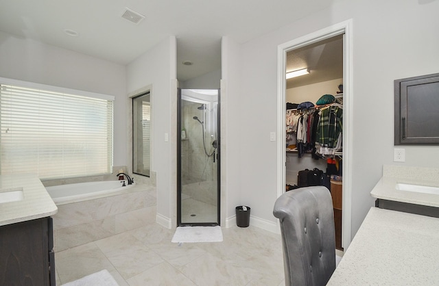 bathroom featuring vanity and plus walk in shower