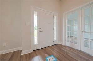 entrance foyer featuring wood finished floors and baseboards