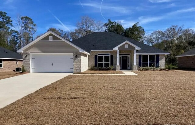 craftsman-style home featuring an attached garage, concrete driveway, and brick siding