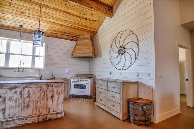 kitchen featuring premium range hood, wooden walls, white range with gas cooktop, finished concrete flooring, and lofted ceiling
