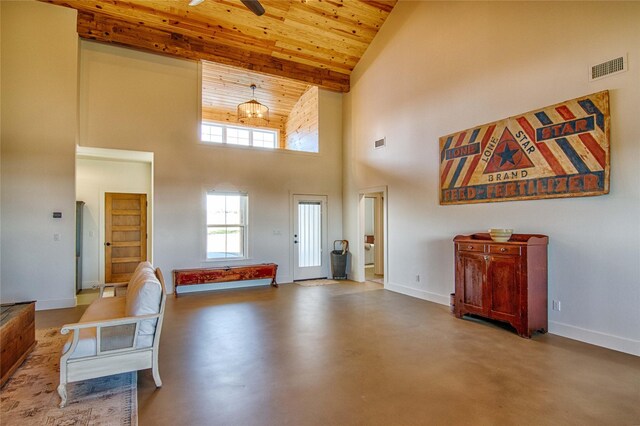 entryway with baseboards, wooden ceiling, a ceiling fan, high vaulted ceiling, and finished concrete floors