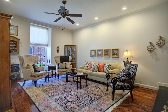 living room featuring ornamental molding, ceiling fan, and dark hardwood / wood-style flooring