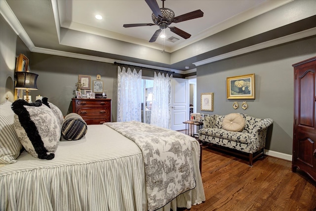 bedroom with a raised ceiling, crown molding, ceiling fan, and dark hardwood / wood-style flooring