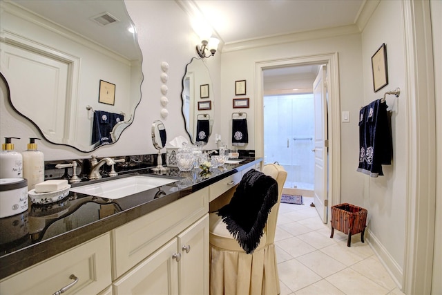 bathroom with crown molding, vanity, and tile patterned flooring