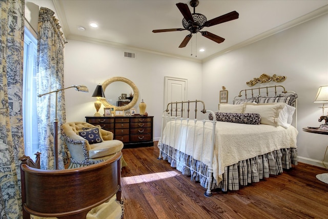 bedroom with dark wood-type flooring, ceiling fan, and crown molding
