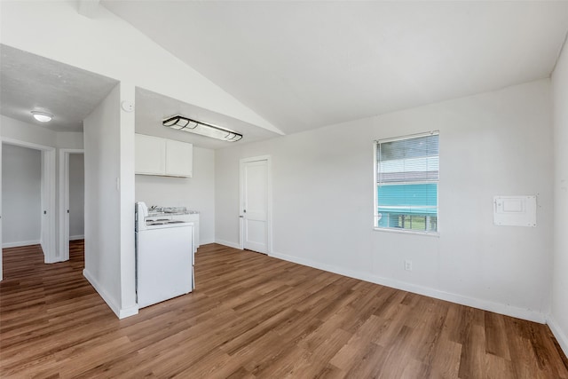 kitchen with lofted ceiling, light hardwood / wood-style floors, white gas stove, and white cabinets