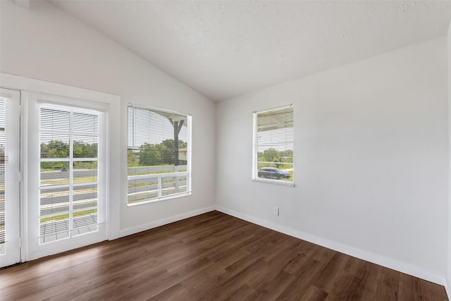 unfurnished room with dark wood-type flooring and vaulted ceiling