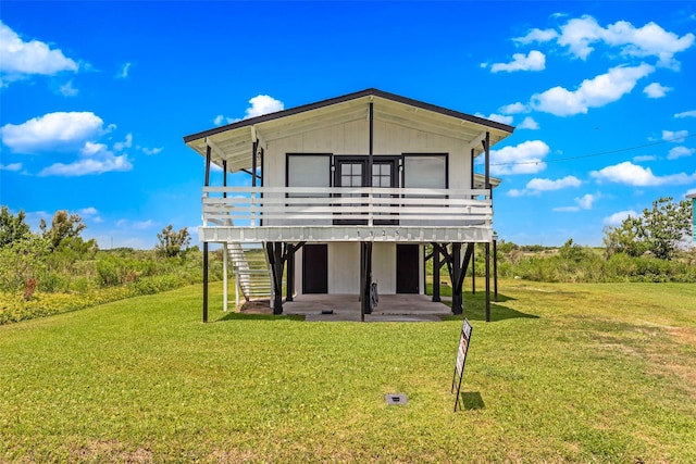 back of property featuring a patio area and a lawn