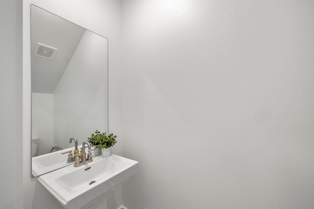 bathroom featuring sink and toilet