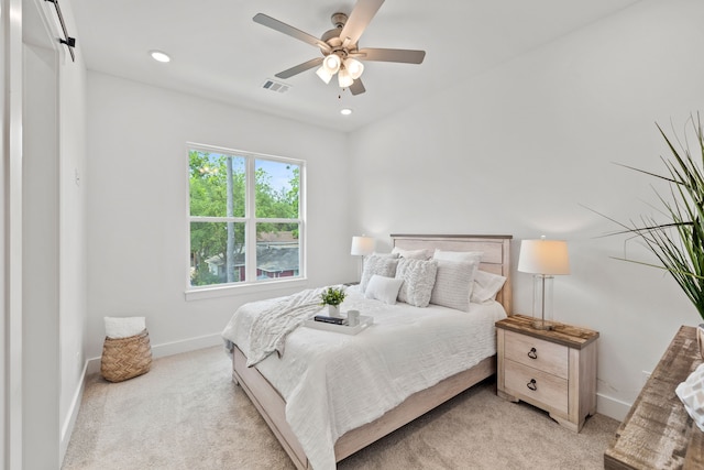 bedroom with ceiling fan and light colored carpet