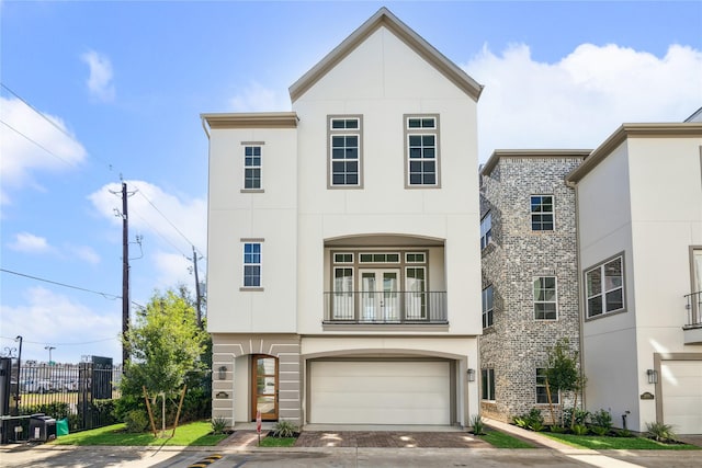 view of front of home with a garage and a balcony