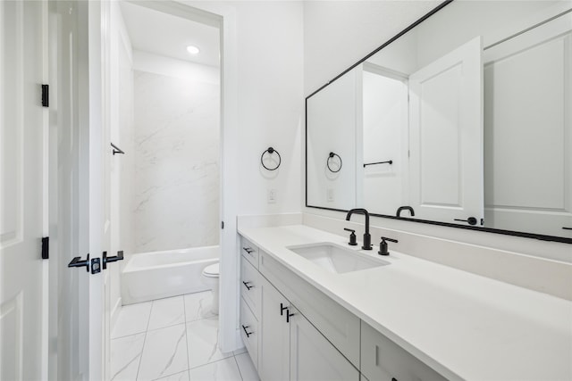 full bathroom featuring vanity, tiled shower / bath, and toilet