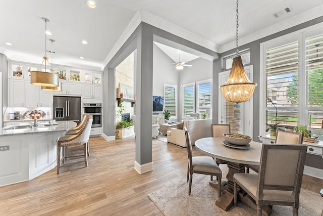 dining area featuring light wood finished floors, visible vents, ornamental molding, ceiling fan with notable chandelier, and recessed lighting