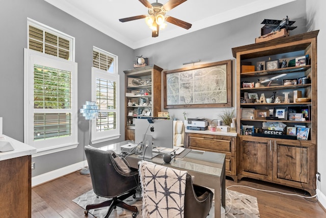 office area featuring ceiling fan, baseboards, crown molding, and wood finished floors