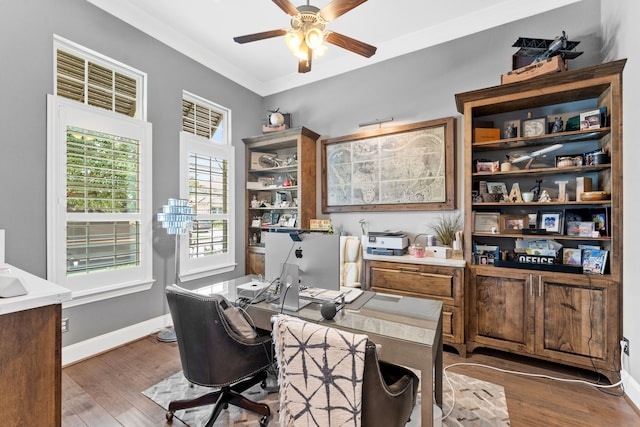 office space with crown molding, ceiling fan, wood finished floors, and baseboards