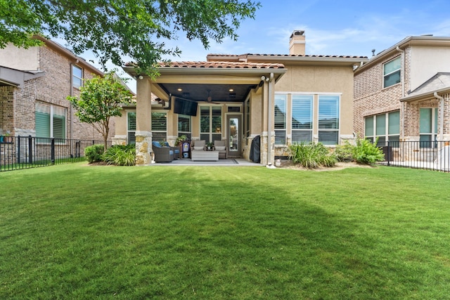 back of house featuring a yard, a chimney, stucco siding, a patio area, and fence