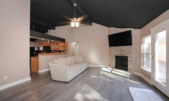 living room with ceiling fan, a fireplace, high vaulted ceiling, and wood-type flooring