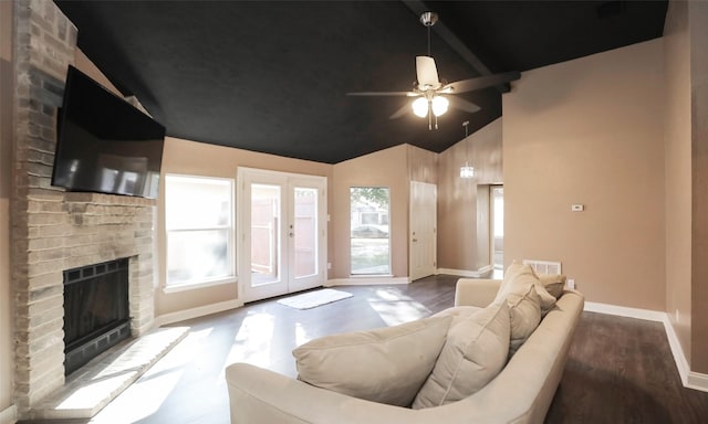 living room featuring a brick fireplace, a healthy amount of sunlight, hardwood / wood-style floors, and ceiling fan